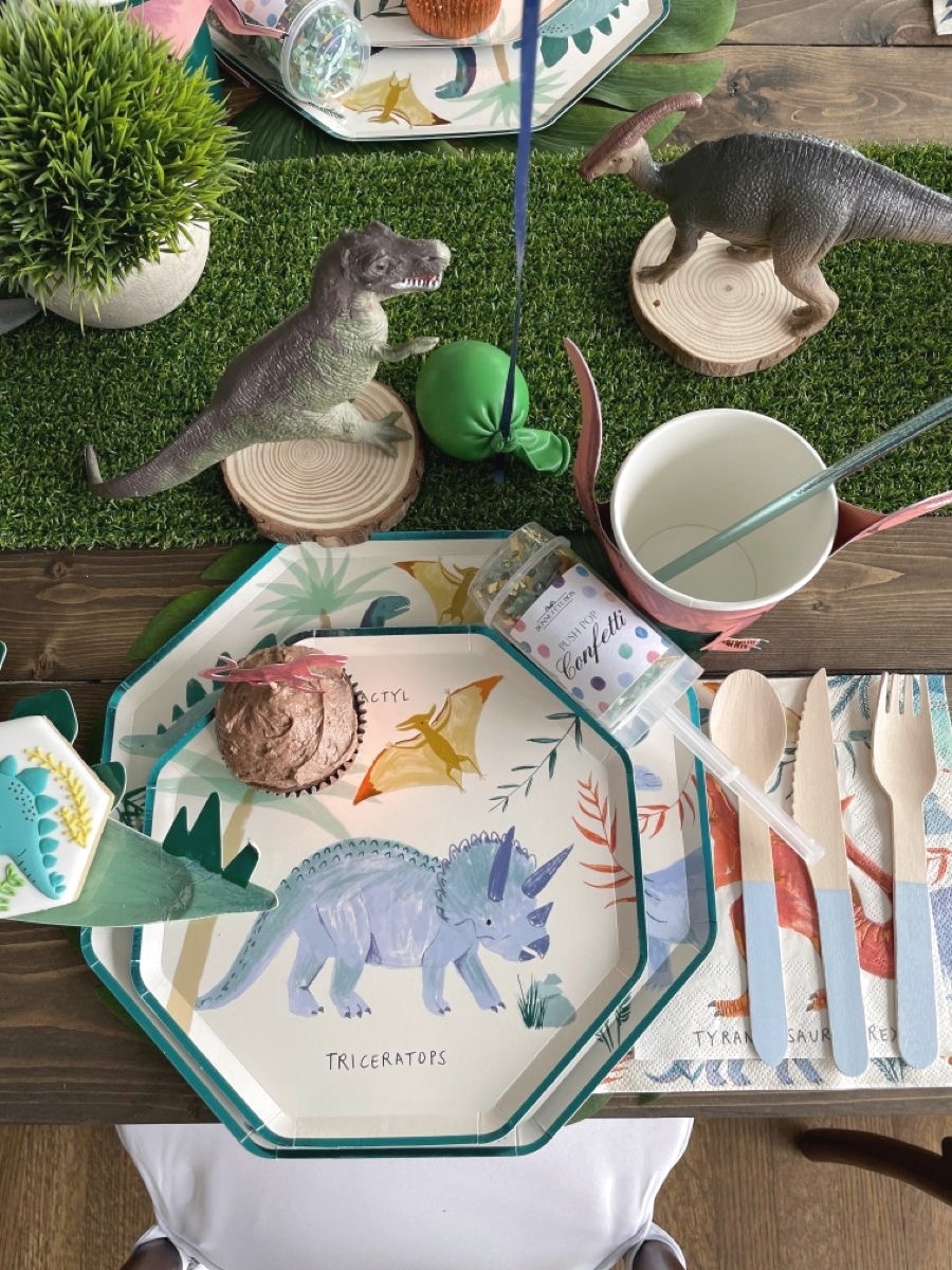 Overhead detail of a place setting on a grass runner